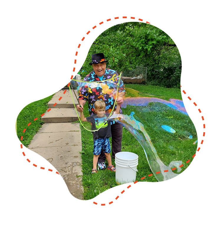 Children and grandfather playing together